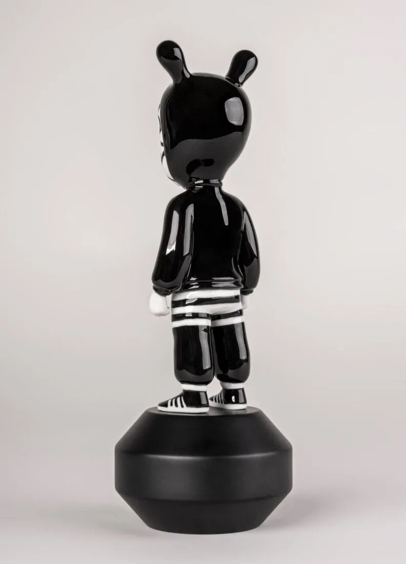 Black and white figurine on a gray background