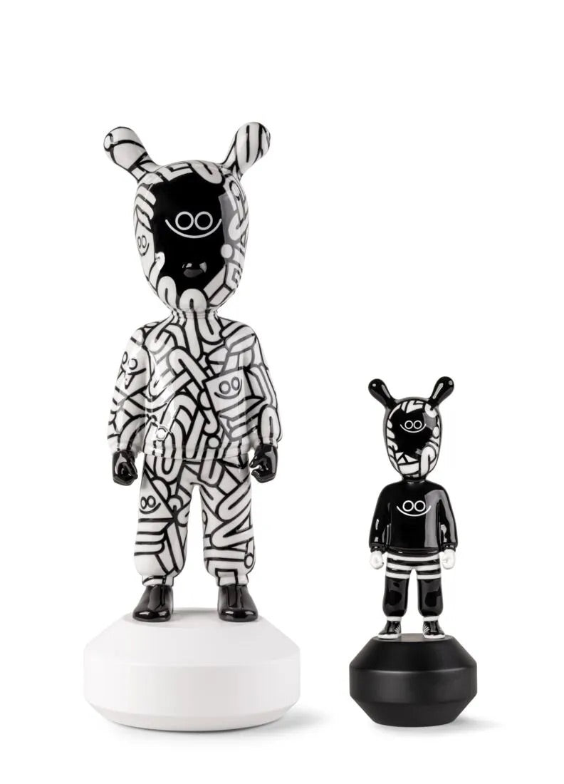 Black and white Guest figurines on a white background