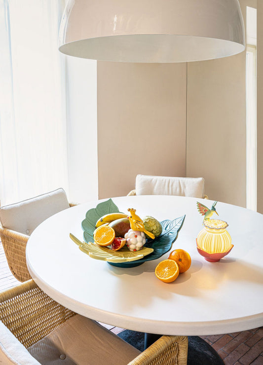 Stylish dining table featuring Lladró Utopical Centrepiece with fruits and Utopical Wireless Lamp.
