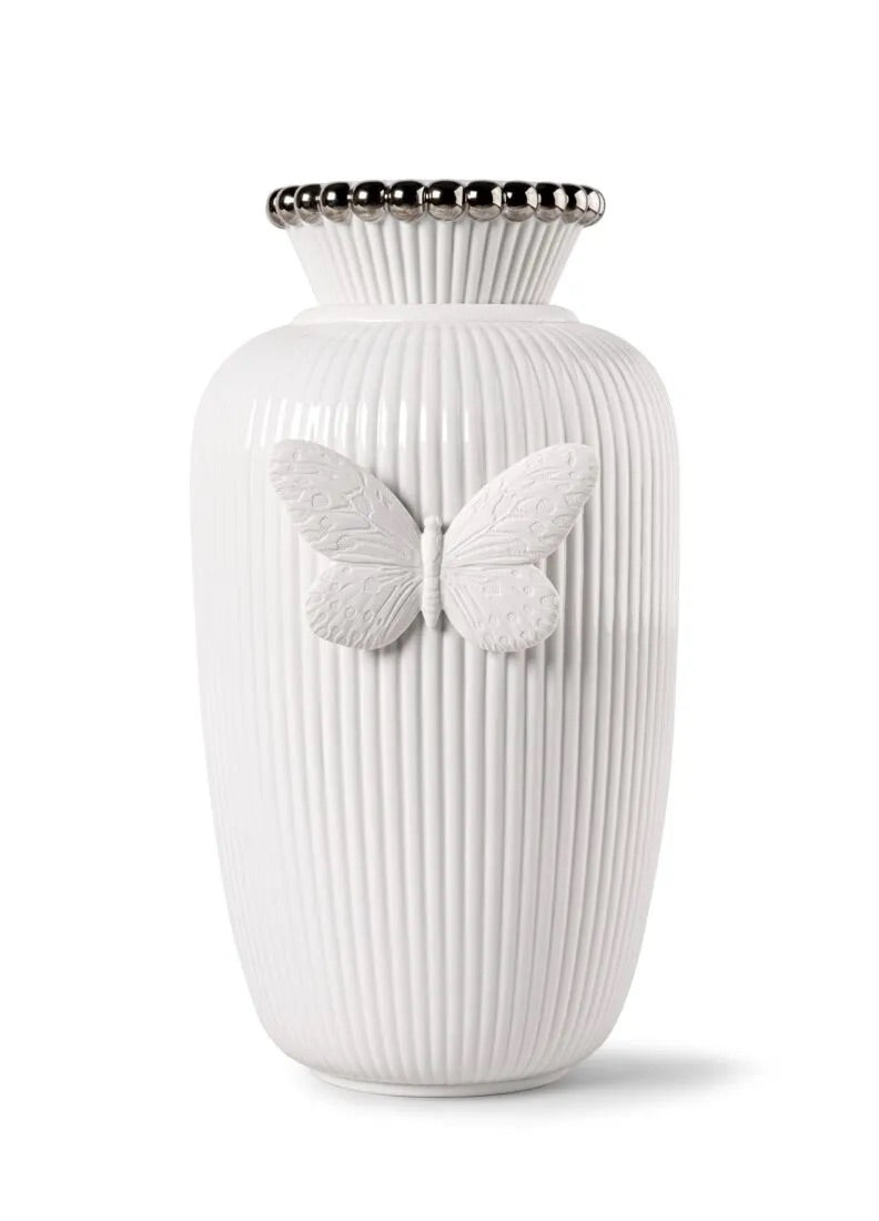 White vase with butterfly designs on a white background