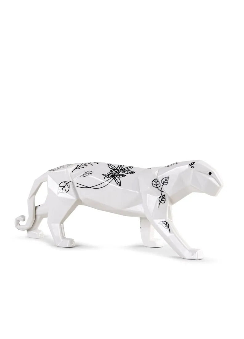 White porcelain panther figurine with black floral designs on a white background