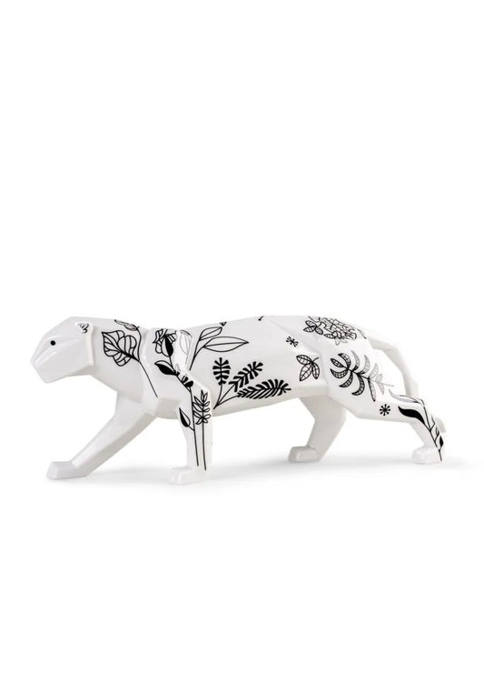 White panther figurine with black floral patterns on a white background