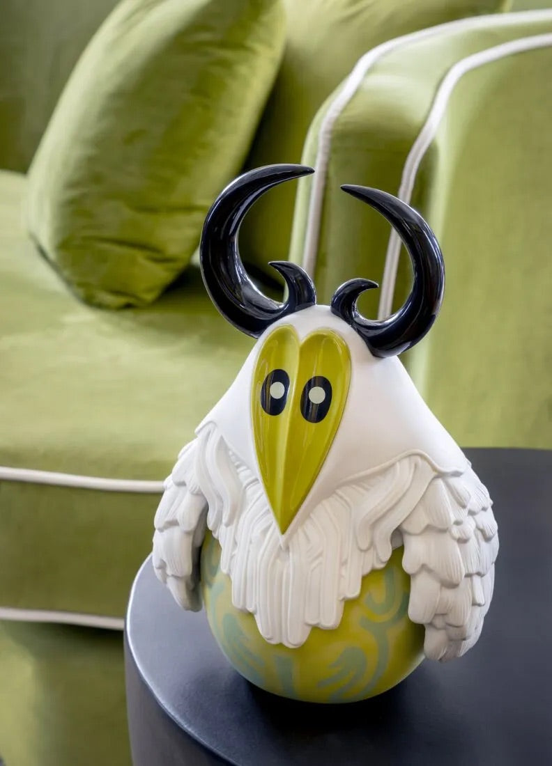 Decorative Yokai - Tengu with black horns on a black table with green couch in background