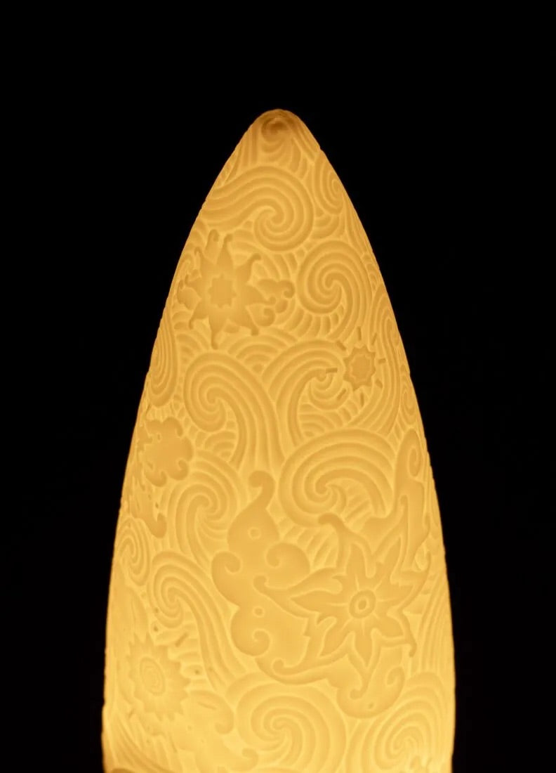 Decorative wireless lamp with intricate patterns on a black background