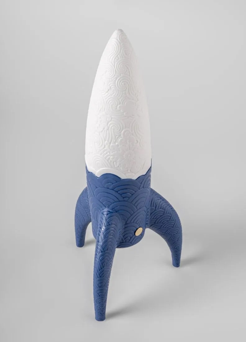 Blue and white rocket-shaped wireless lamp on a white background