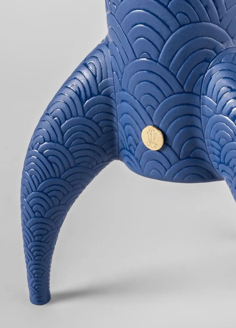 Blue textured wireless lamp with a gold accent on a gray background