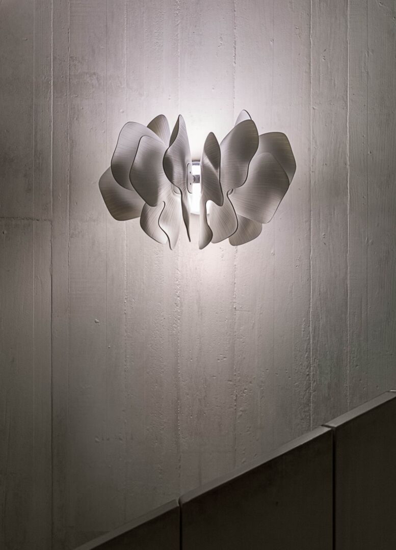 Lladró Nightbloom wall sconce featuring elegant white porcelain design and soft glowing light