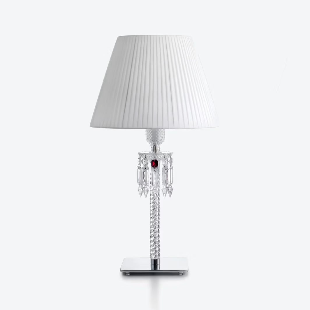 Table lamp with a white pleated shade on a white background