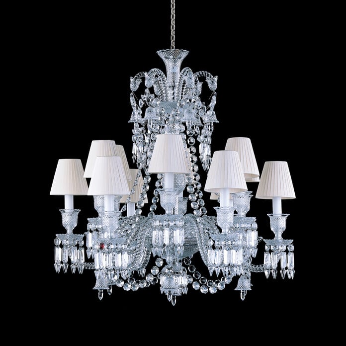 Baccarat Crystal Zenith chandelier with white lampshades on a black background
