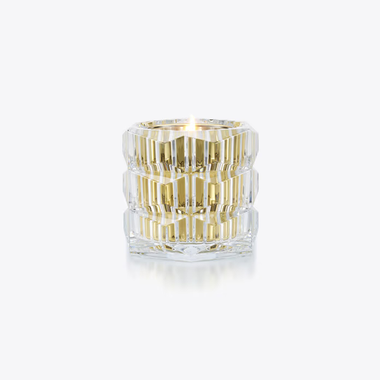 Baccarat clear glass candle with gold stripes on a white background