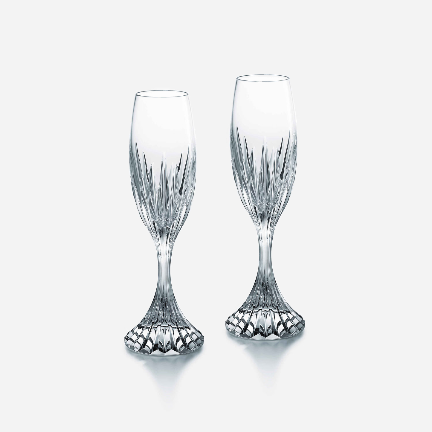 Two crystal champagne flutes on a white background
