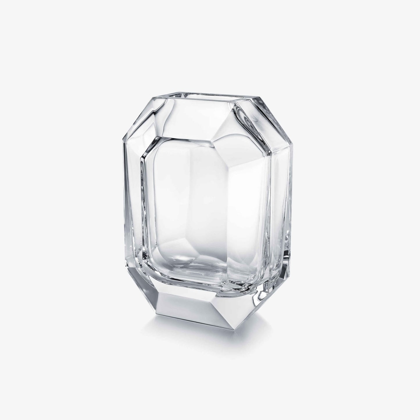 Clear glass vase with faceted design on a white background