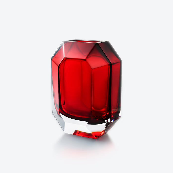 Red glass vase with geometric design on a white background