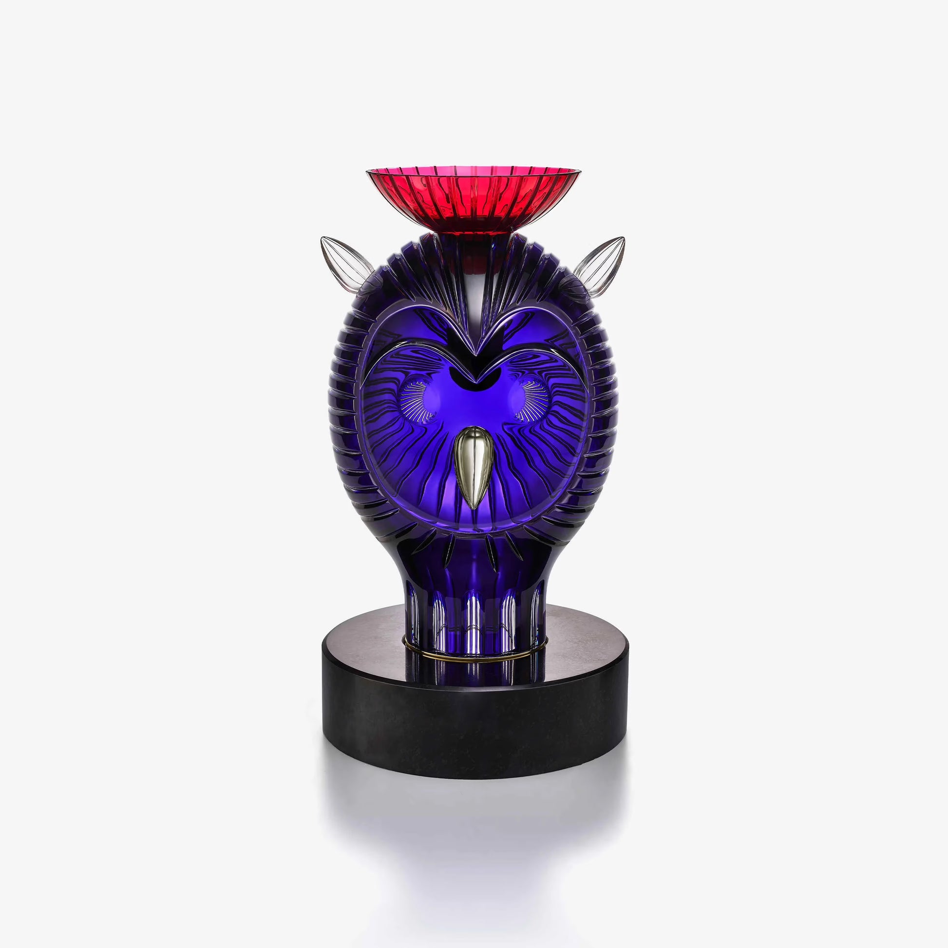 Decorative crystal owl with purple and red design on a white background