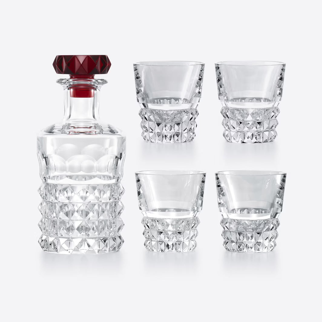 Set of Baccarat crystal glasses with a decanter on a white background