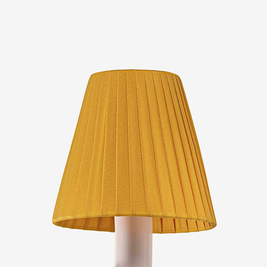 Yellow pleated lampshade on a white background