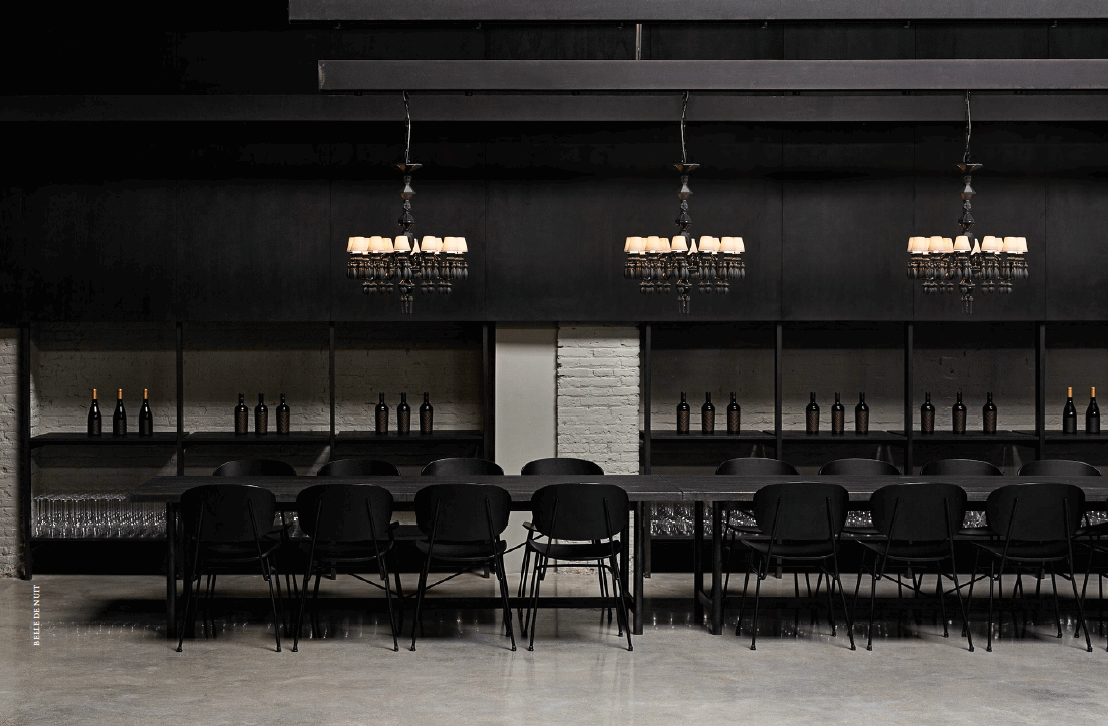 Elegant Lladró chandelier enhancing the modern dining area with stylish black decor