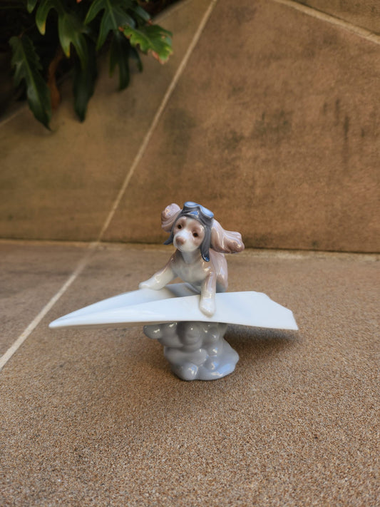 Lladró Lets Fly Away on a Paper Plane Dog Sculpture