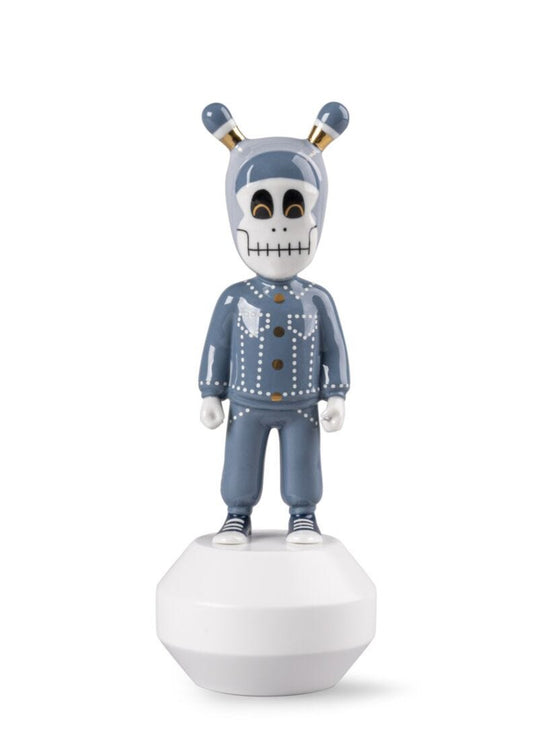 A stylized collectible figurine of a skeleton character wearing a blue denim jacket and matching pants, standing on a white dome base against a plain white background.