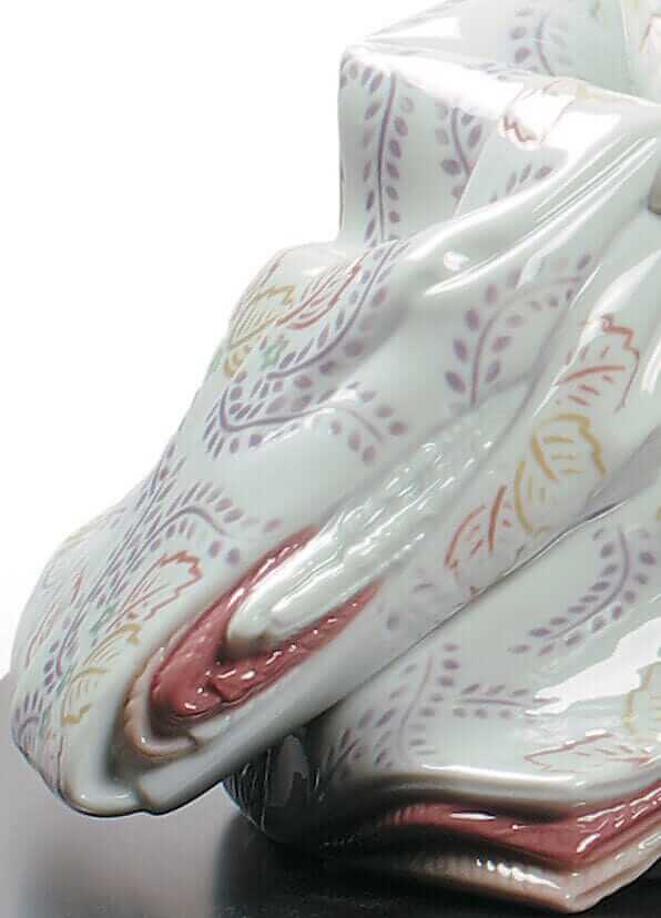 Close-up of a beautifully detailed porcelain Hina Doll figurine showcasing intricate floral patterns and elegant colors.