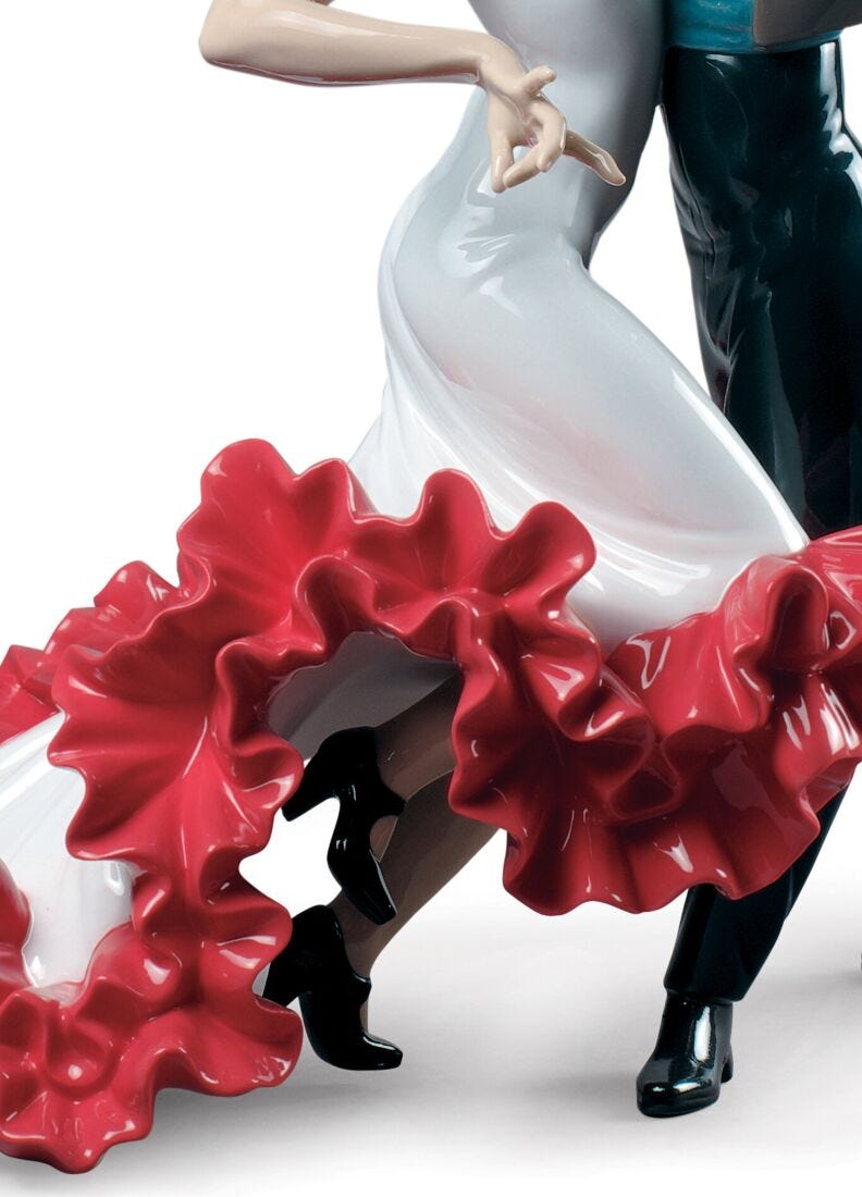 Dancing couple figurine with red skirt and white top on a white background