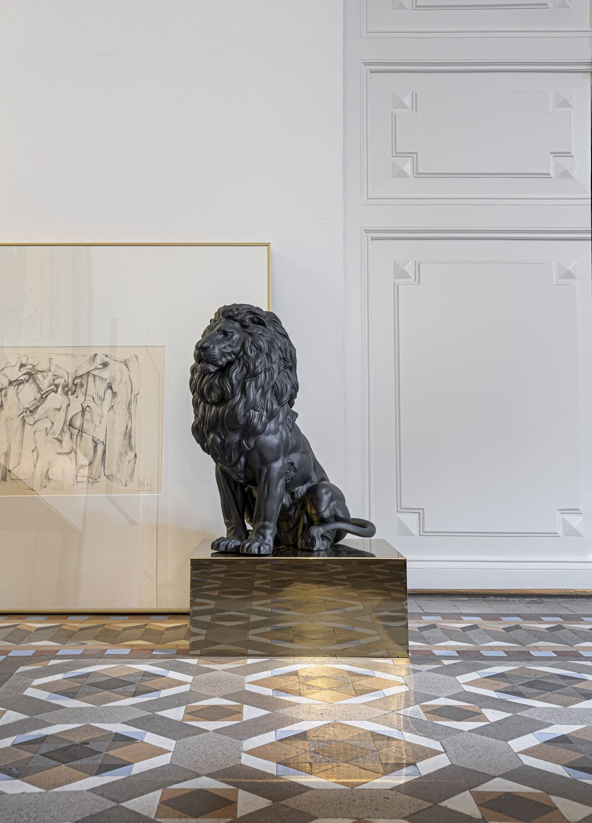 Lladró Majestic Lion Sculpture in matt black porcelain, showcasing strength and serenity in a modern interior setting.