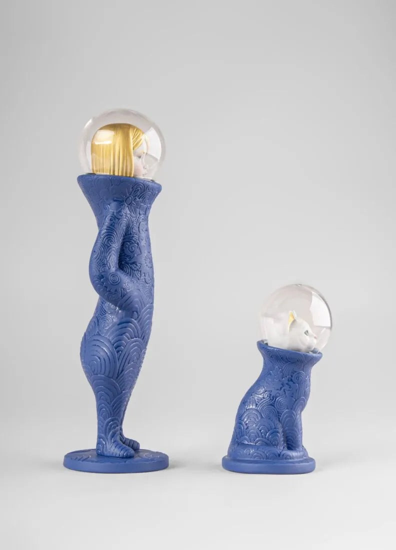 Blue porcelain figure with a cat and a woman inside glass bubbles on a white background