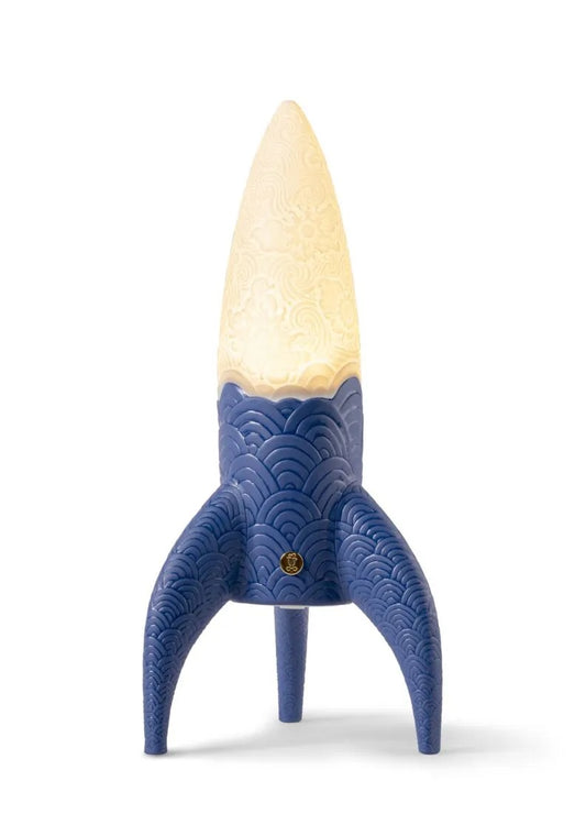 Blue rocket-shaped lamp with a white bulb on a white background