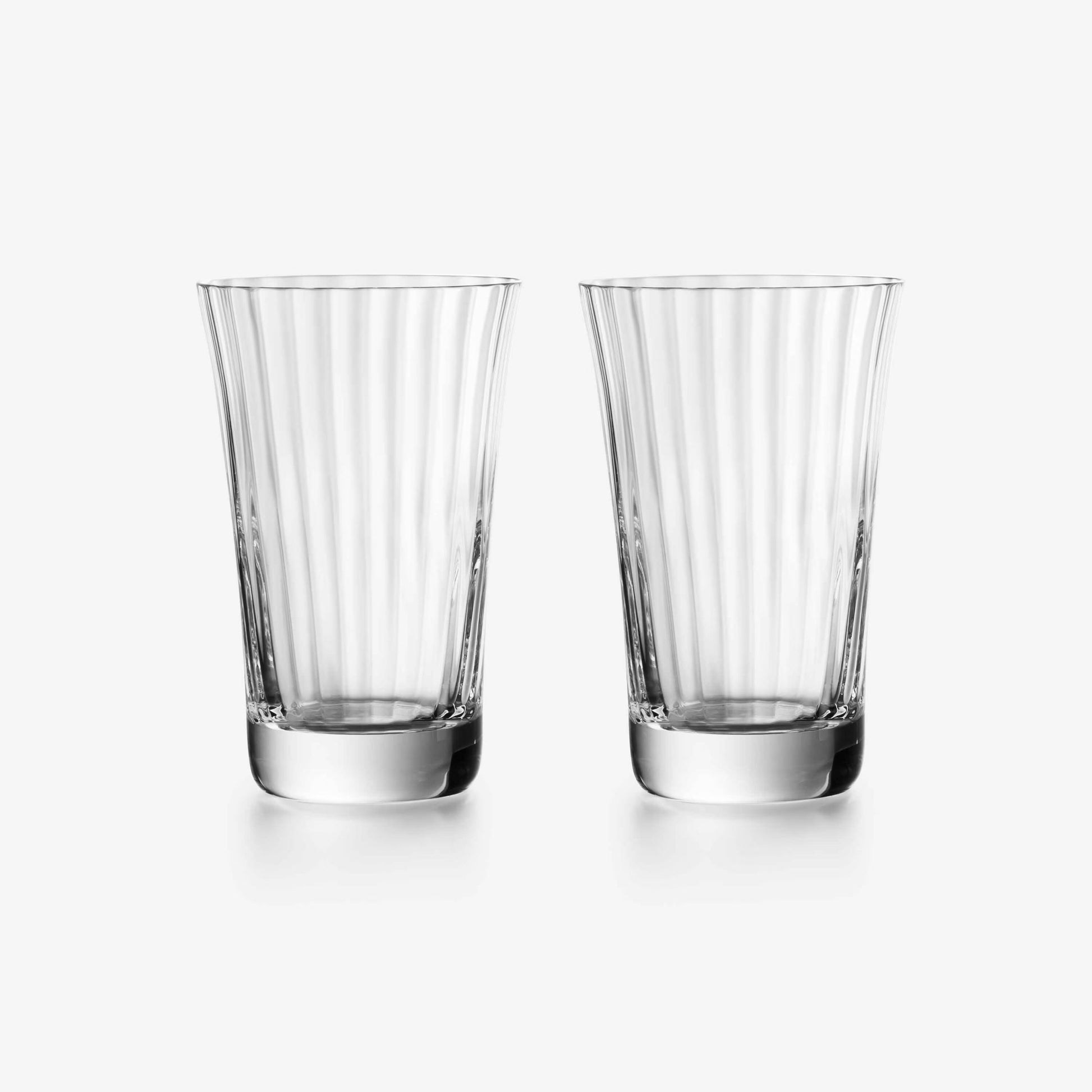 Two clear glass tumblers with vertical stripes on a white background