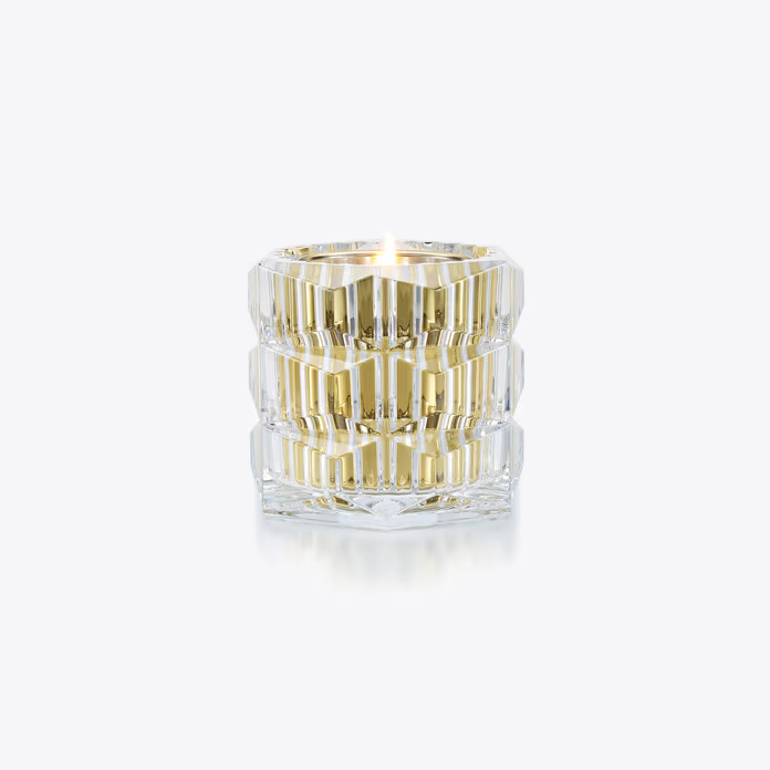 Baccarat clear glass candle with gold stripes on a white background