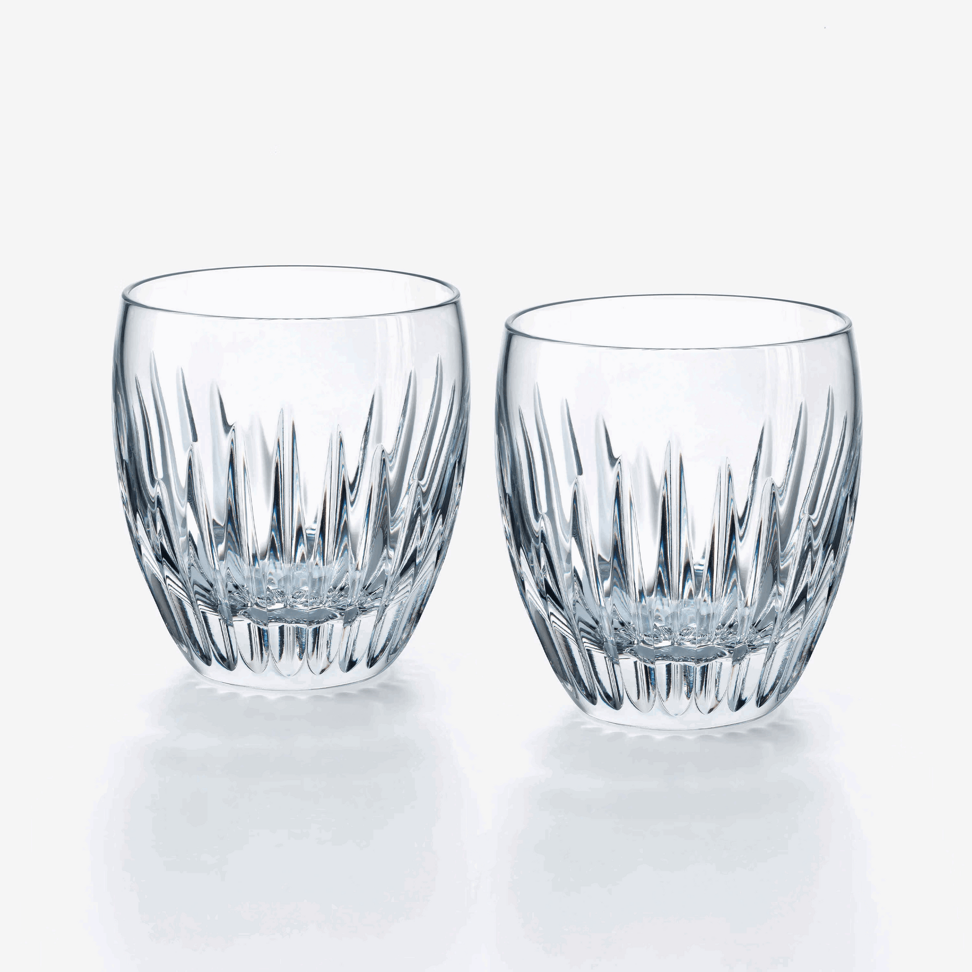 Two clear crystal tumblers with a textured design on a white background