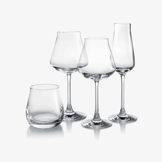 Set of four clear glass wine glasses on a white background