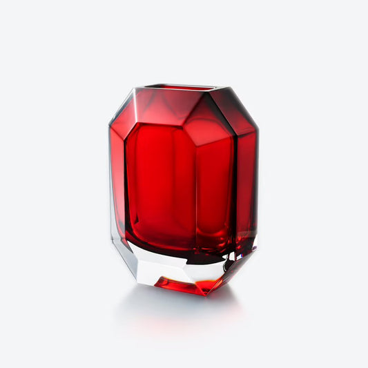 Red glass vase with geometric design on a white background