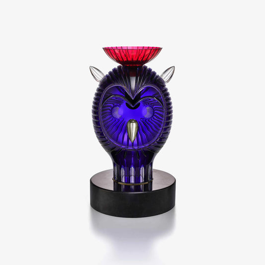 Decorative crystal owl with purple and red design on a white background