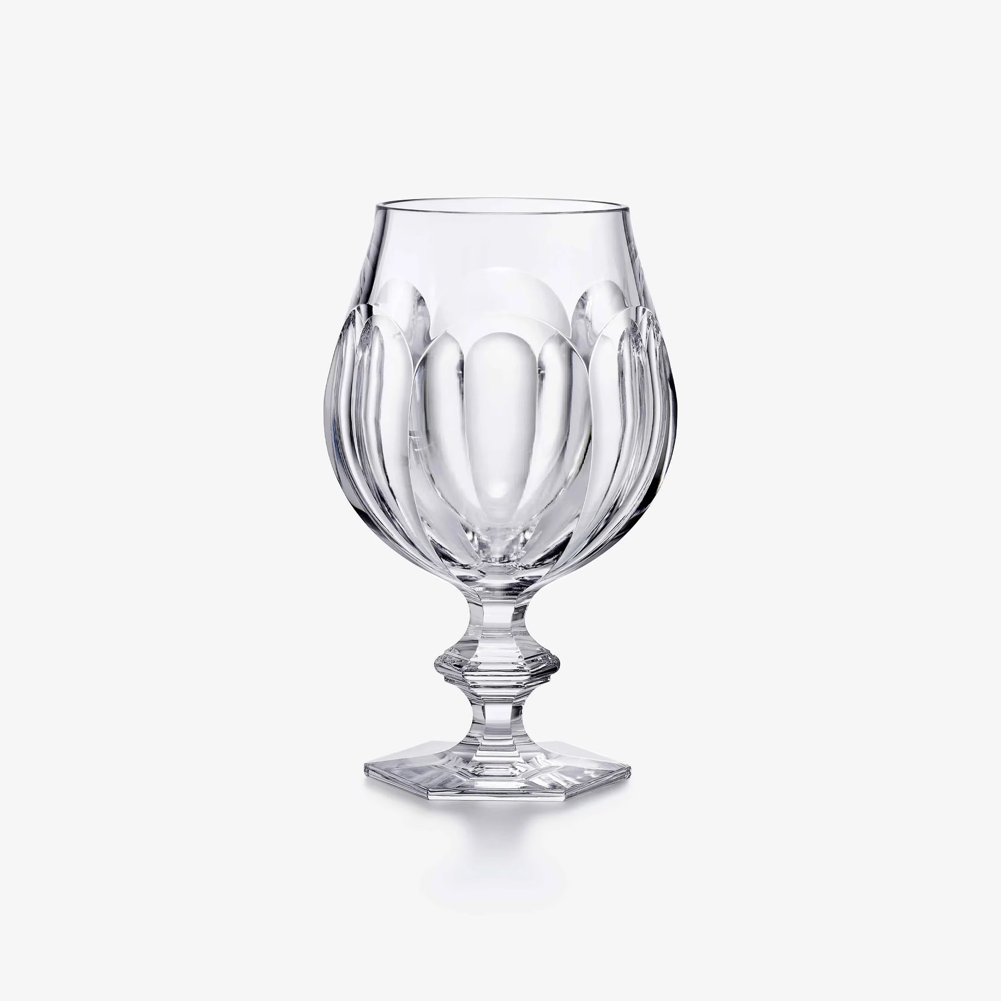 Clear glass goblet on a white background