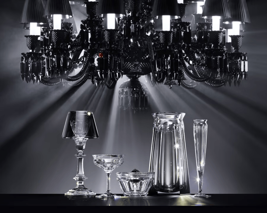 Chandelier with various crystal glassware on a reflective surface