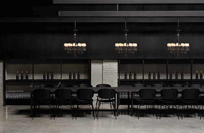 Elegant Lladró chandelier enhancing the modern dining area with stylish black decor